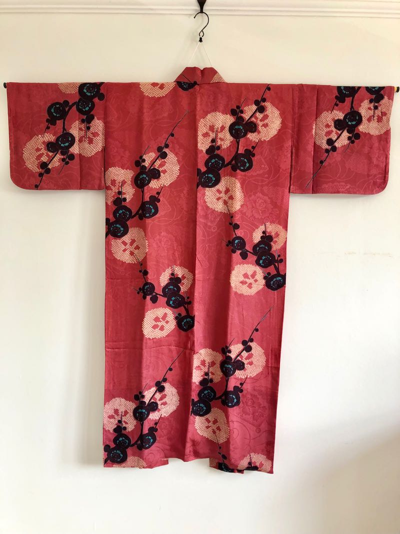 Elegant red and gold silk kimono inspired by Memoirs of a Geisha movie featuring traditional Japanese patterns and luxurious fabric